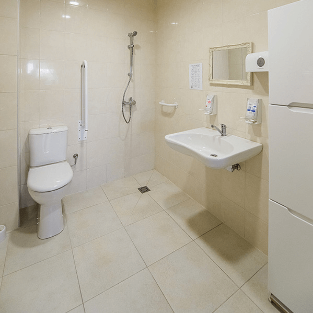 Pritaikytas vonios kambarys su dušu, turėklais ir plačia erdve